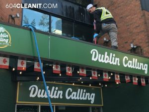 a man cleaning the roof of the restaurant